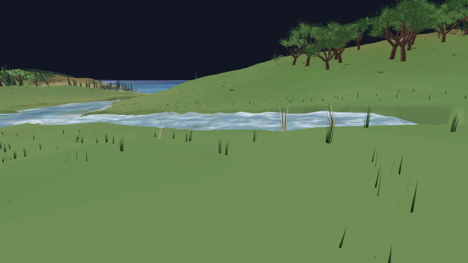 A stream bank at close range with dark upright rushes on the grass and pale reeds at the water